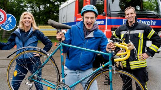 Der Fahrrad-Check / Checker Julian (Mitte) mit ADAC-Verkehrsexpertin Melanie und Feuerwehrmann Anselm.
