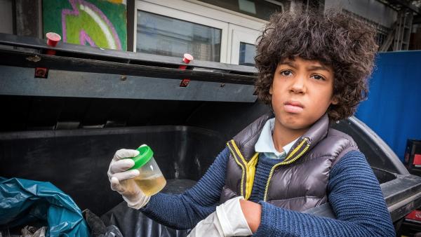 Femi (Spencer König) findet im Müll eine Urinprobe. | Rechte: NDR/Boris Laewen