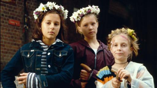 Jana, Natascha und Vivi haben Blumenkränze auf dem Kopf.