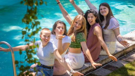 Sienna, Greta, Karima, Florentin und Pauline sitzen am Pool