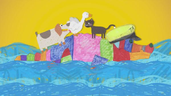 Ein buntes Steckkkrokodil schwimmt durch ein gemaltes Meer. Es hat eine Kapitänsmütze auf den Kopf. Auf seinem Rücken sitzen ein Hund, eine Gans und eine Katze. | Rechte: KiKA