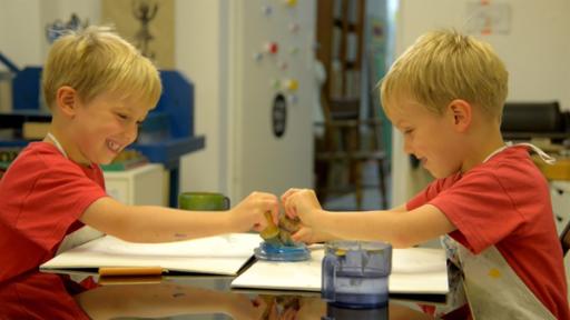 Justus und Lorenz malen mit Wachs.