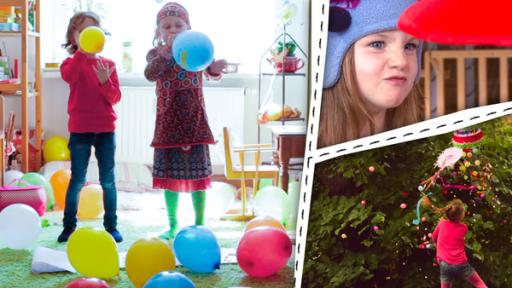 Kinder spielen mit Luftballons und versuchen nicht zu lachen. Ein Mädchen spielt mit einer Pinata.