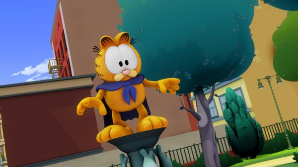 Garfield genießt seinen Ruhm als Superheld. Mittlerweile gibt es sogar schon Actionfiguren vom "Rächer mit dem Umhang". | Rechte: HR/DARGAUD MEDIA