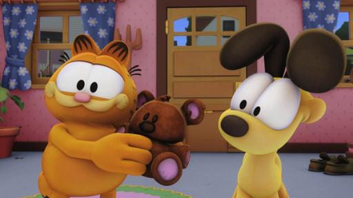 Garfield zeigt Odie einen Teddybär.