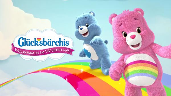 Das blaue Brummbärchi und das pinke Hurrabärchi schlittern auf dem Regenbogen.