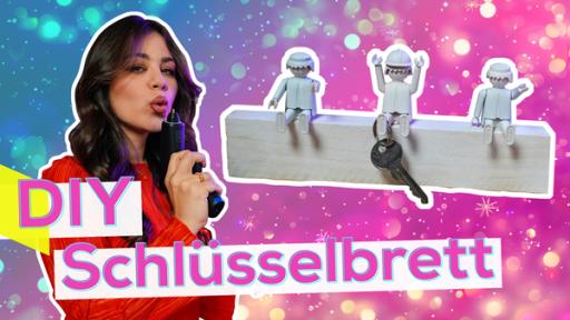 Sarah mit Heißklebepistole. Neben ihr Bild von einem Brett mit Figuren mit weißer Umrandung. Aufschrift: DIY Schlüsselbrett