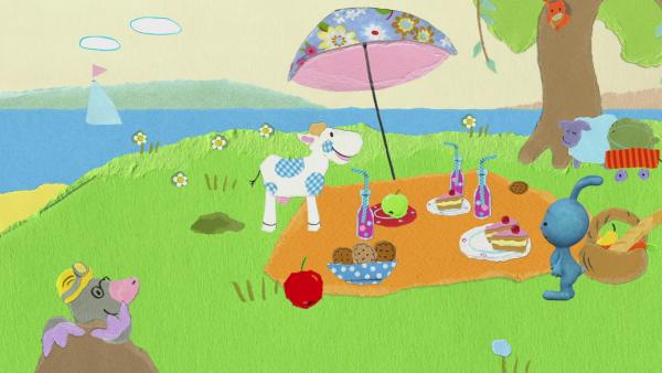 Kikaninchen macht ein Picknick mit vielen Freunden auf einer Wiese