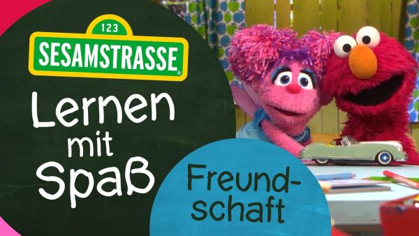 Abby und Elmo mit dem Logo "Lernen mit Spaß" | Rechte: NDR/Sesamstsraße Foto: Grafik