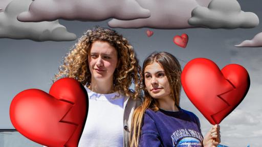 Angelina (links) und Emma (rechts) aus der Sendug "Mädchen WG" stehen nebeneinander und schauen ernst in die Ferne. Beide halten mit einer Hand einen gezeichneten Herzluftballon. Beide Herzballons sind in der Mitte in zwei Teile gerissen, die durch eine Zackenlinie getrennt sind. Im Hintergrund sind gezeichnete graue Wolken zu sehen.